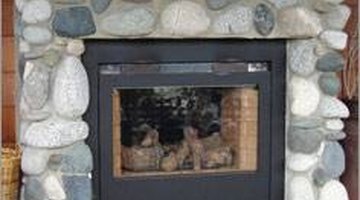 Installing river rock to your fireplace surround is a moderately simple do-it-yourself project.